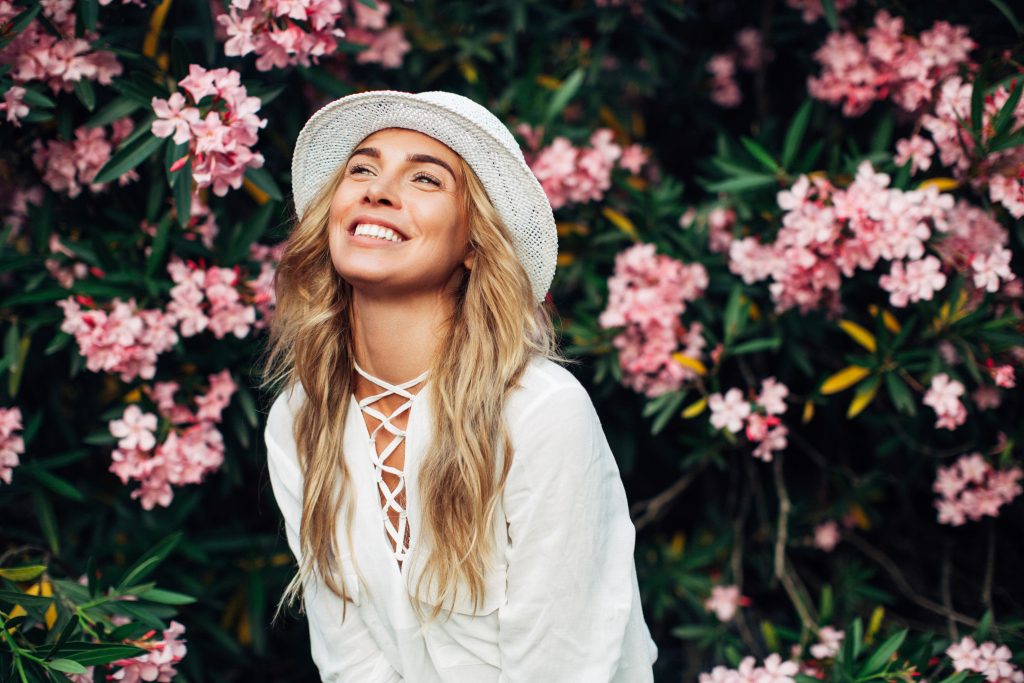 Beautiful girl on the background of spring bush