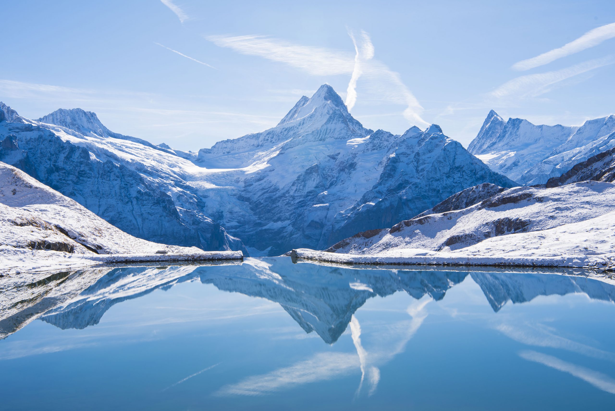 Switzerland, reflection of Firist Bachalsee Lake. The Alps reflected in the snowy Bachalsee Lake.