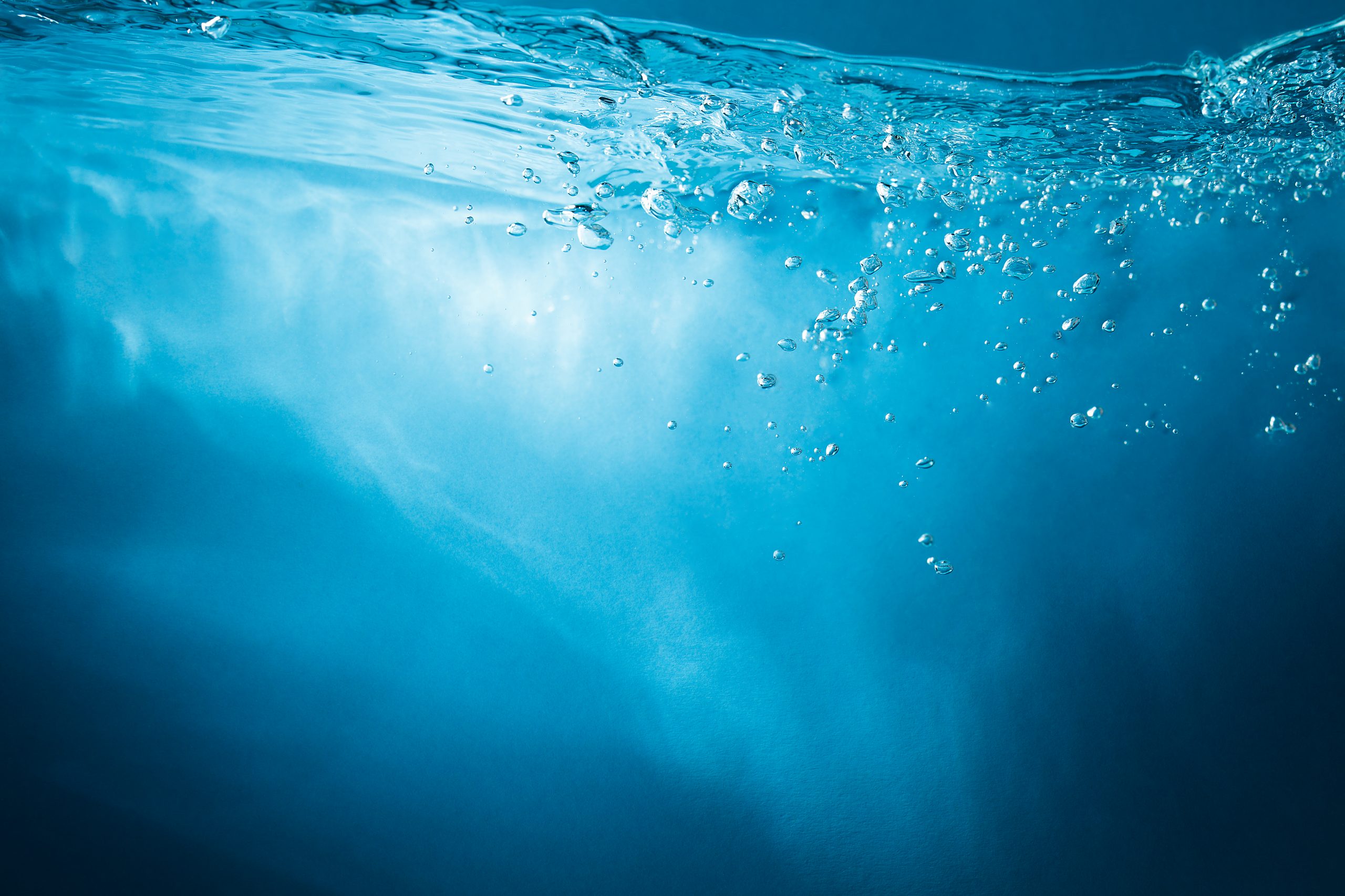 Abstract blue background. Water with sunbeams Abstract blue background. Water with sunbeams