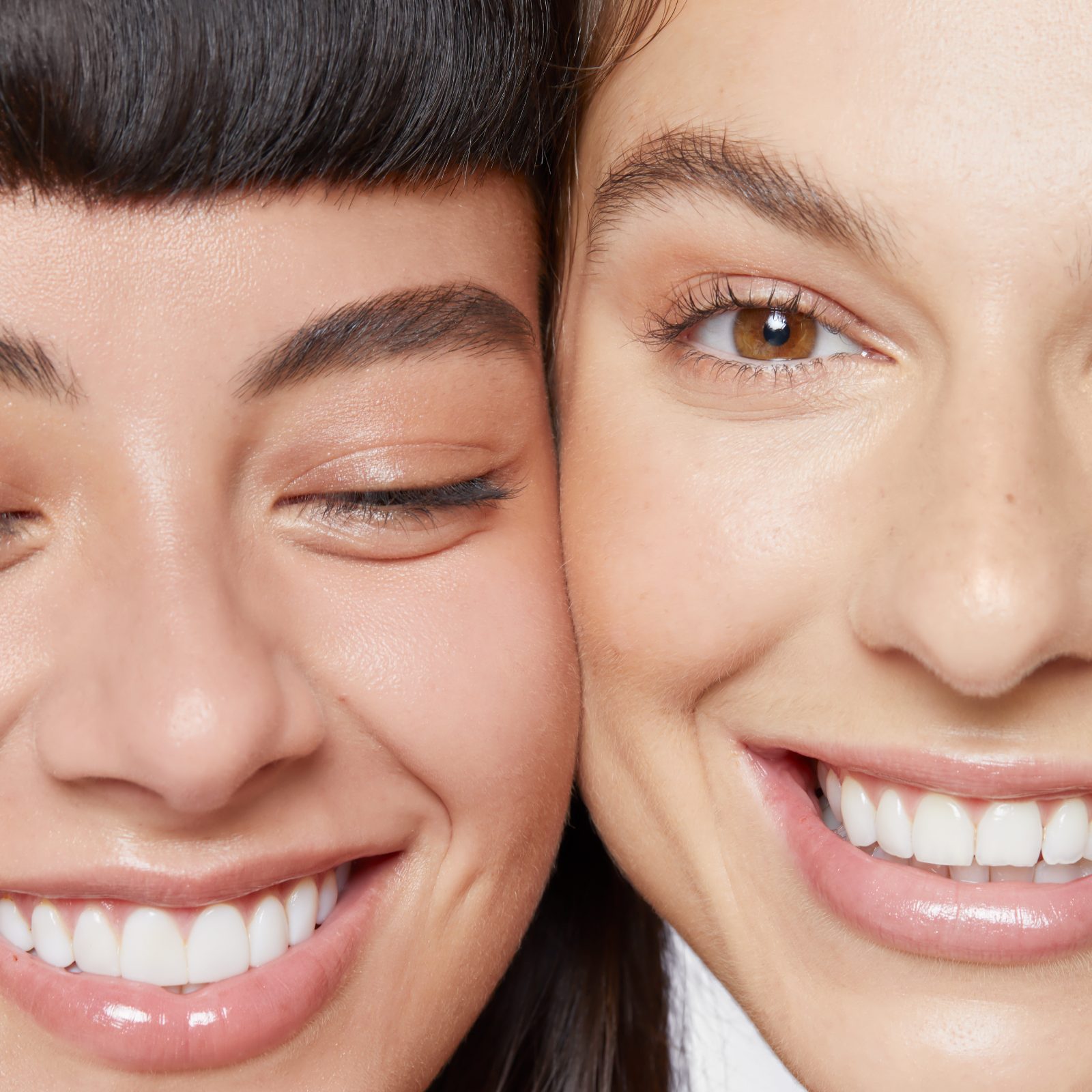 2 females with faces side by side laughing 2 females with faces side by side laughing