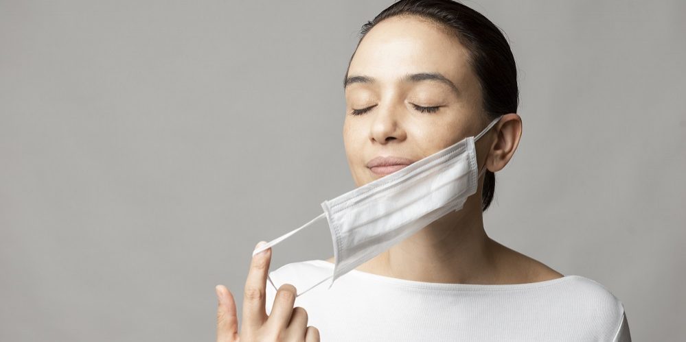 Woman opening her face mask.