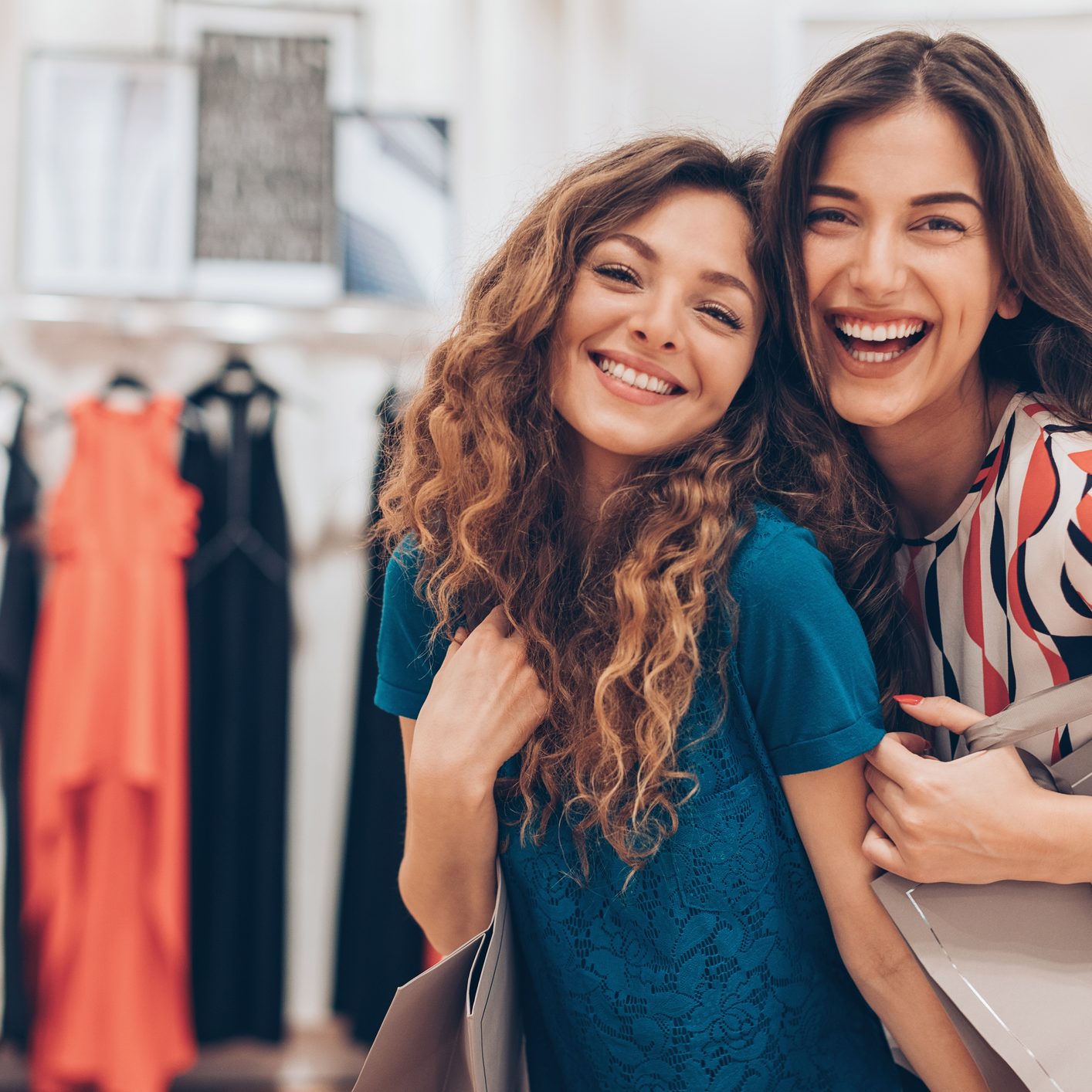 Happy girfriends in a fashion store