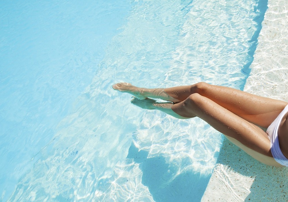 Beautiful woman legs in swimming pool.