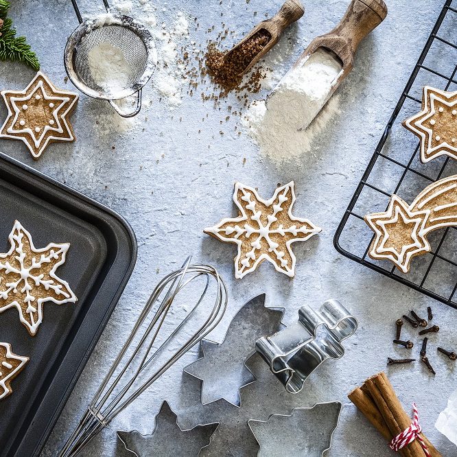 Top view of a gray table with ingredients and utensils for preparing and baking Christmas cookies. Predominant colors are brown and gray. Low key DSRL studio photo taken with Canon EOS 5D Mk II and Canon EF 100mm f/2.8L Macro IS USM