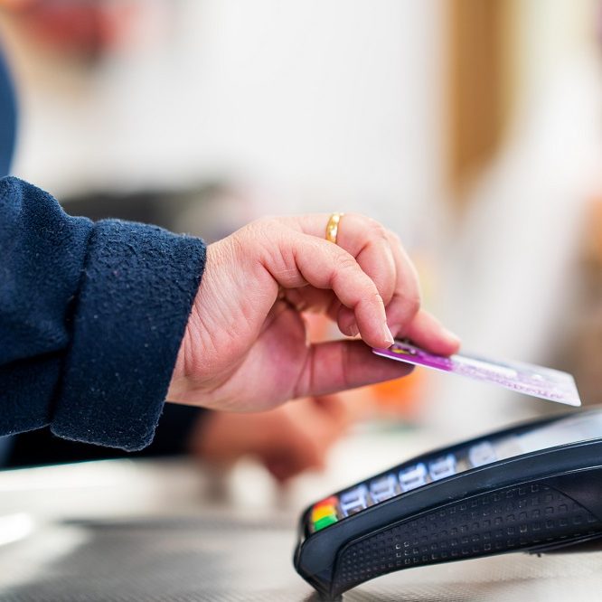 Close up of cashier is using contactless credit card pos terminal to getting the payment