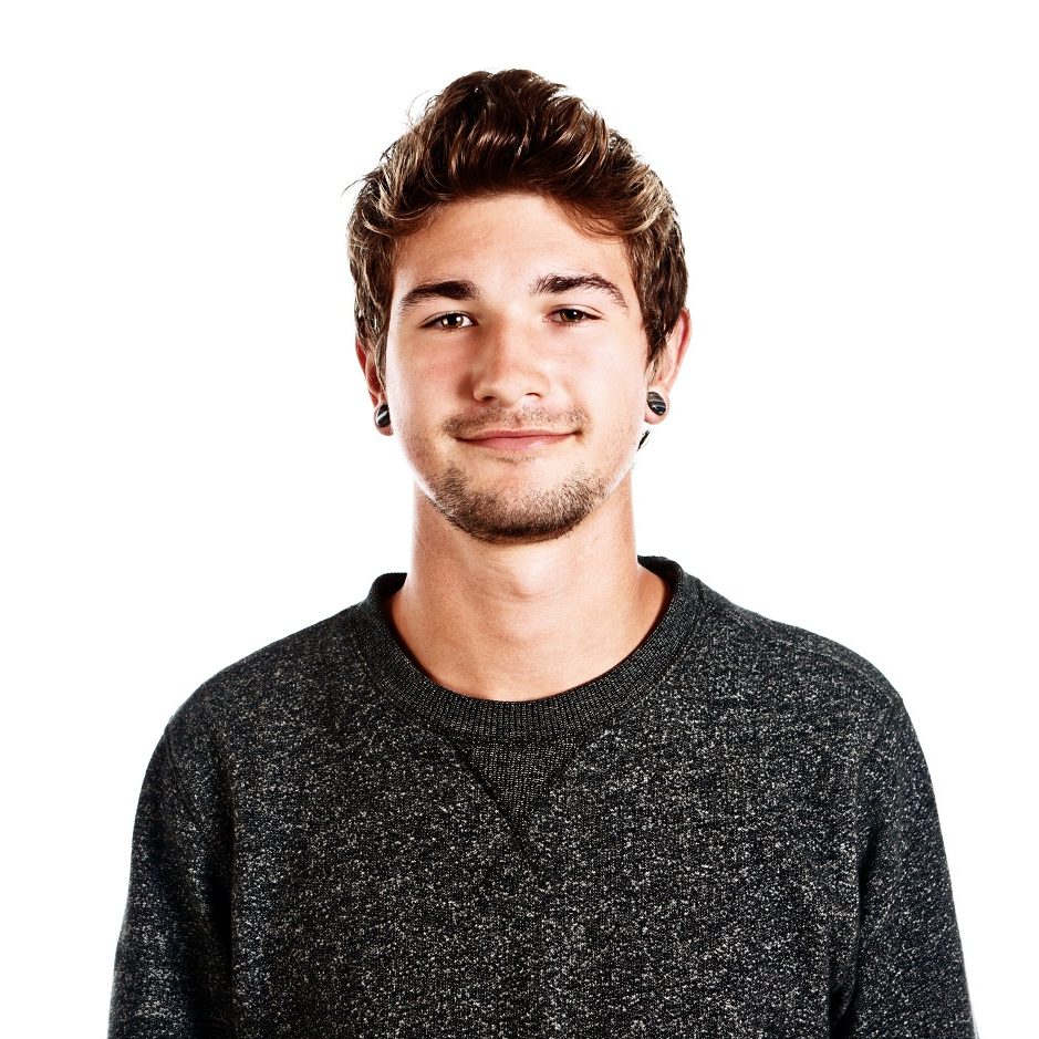 Portrait of good looking young man wearing earrings and smiling gently.  Isolated on white.