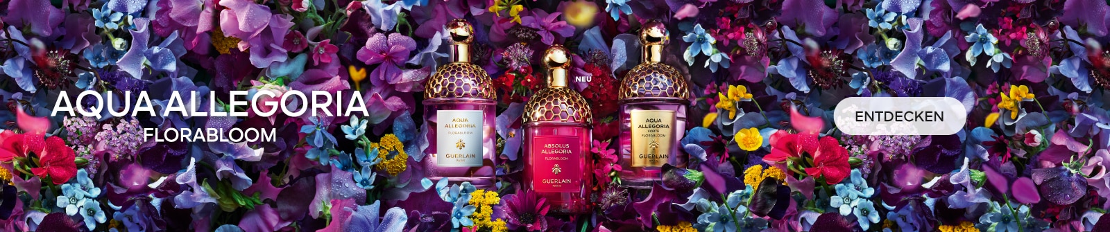 Guerlain Aqua Allegoria Florabloom-Düfte Aqua Allegoria, Absolus Allegoria und Aqua Allegoria Forte, umgeben von lebendigen Blumen in Lila, Blau, Gelb und Rosa.