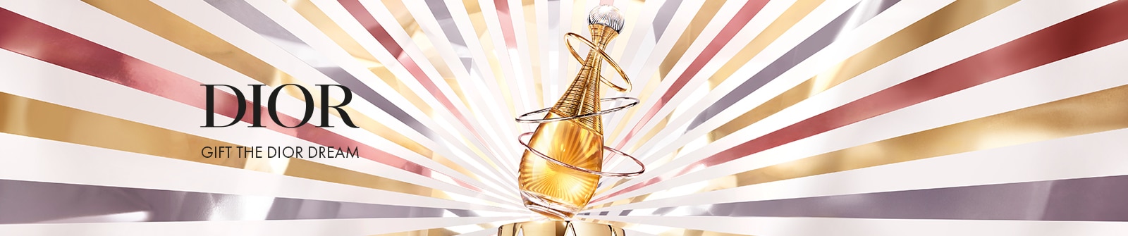 Dior: Get the Dior Dream - Dior J&apos;Adore-Parfümflakon mit goldenem Farbton und drei metallischen Spiralringen, vor einem strahlenden Hintergrund aus goldenen, silbernen und bronzenen Linien.